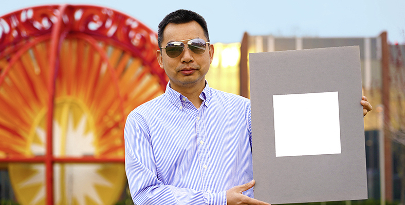 LQ9377094C_picture_0_cropped.jpg Xiulin Ruan, a Purdue University professor of mechanical engineering, holds up his lab’s sample of the whitest paint on record. (Purdue University/Jared Pike)